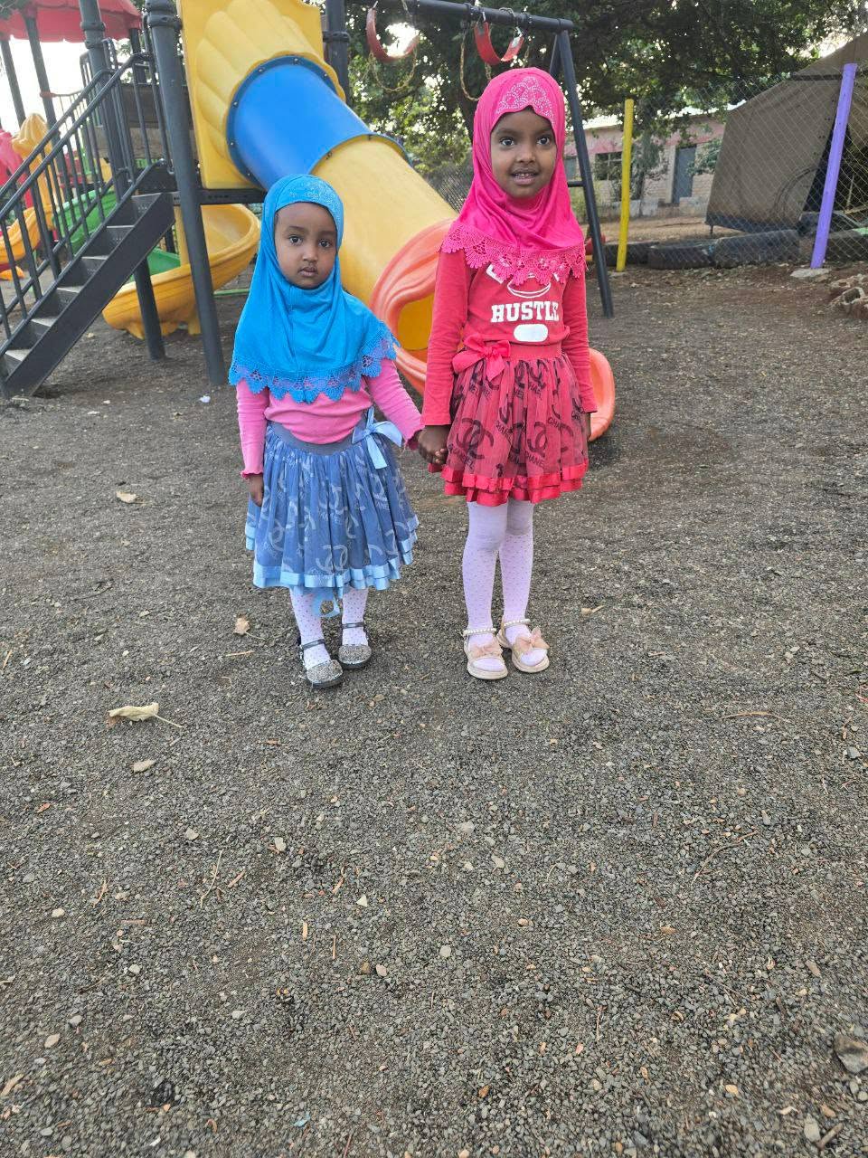 Two children pictured outdoors during the Eid celebration