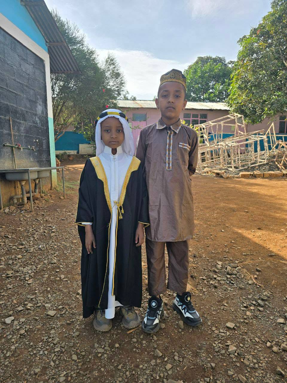 Two children posing outdoors during the Eid celebration