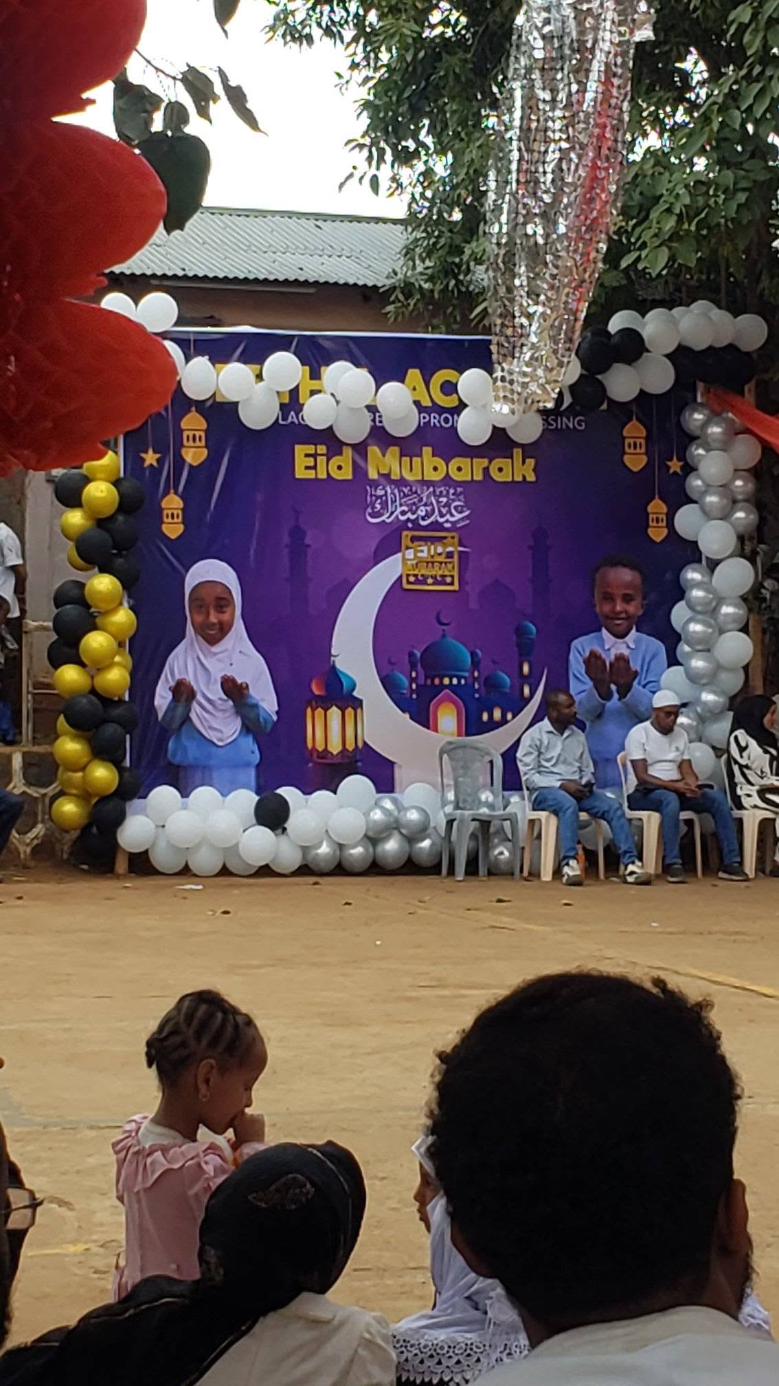 Children pictured on stage with the Eid celebration decorations
