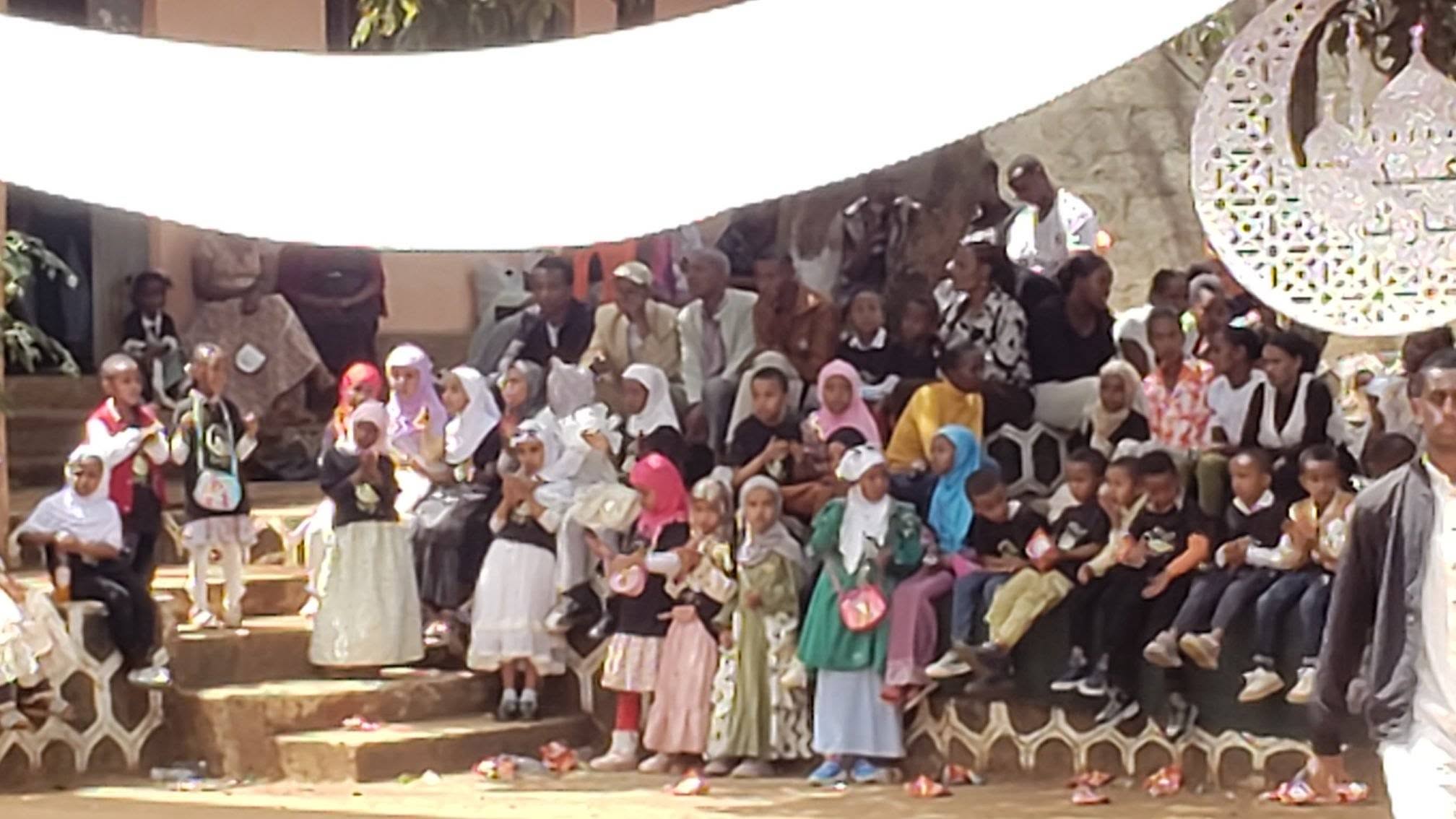 Children and adults gathered in the courtyard for Eid